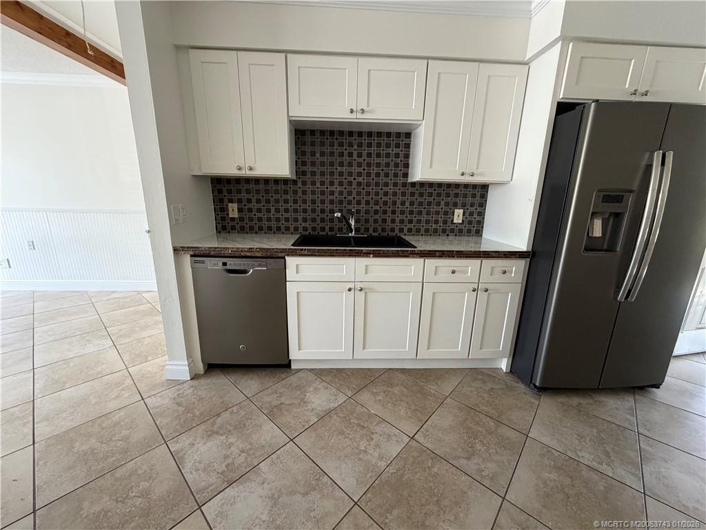 820 Northwest 10th Terrace Stuart, FL 34994 - Photo 2 of 21 a kitchen with cabinets and a refrigerator