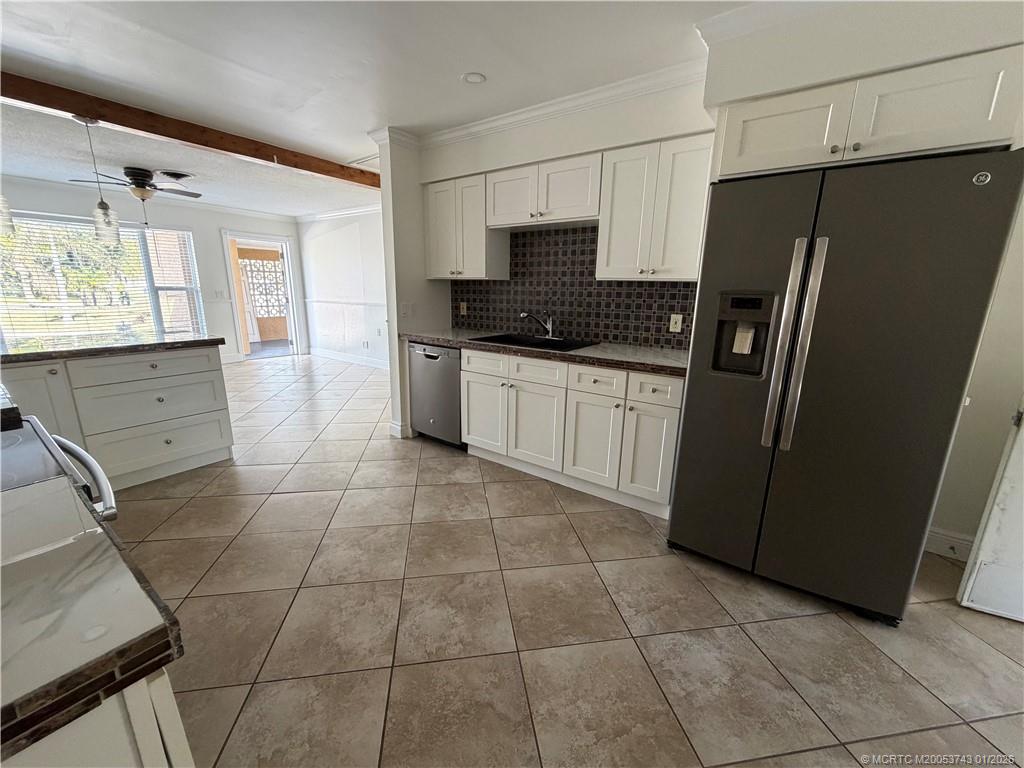 820 Northwest 10th Terrace Stuart, FL 34994 - Photo 5 of 21 a kitchen with stainless steel appliances a refrigerator sink and microwave