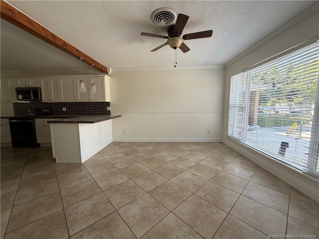 820 Northwest 10th Terrace Stuart, FL 34994 - Photo 10 of 21 a kitchen with stainless steel appliances granite countertop a sink and a stove