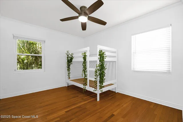 a view of empty room with wooden floor