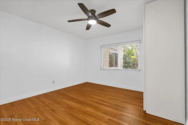 a bathroom with a granite countertop sink a mirror and shower
