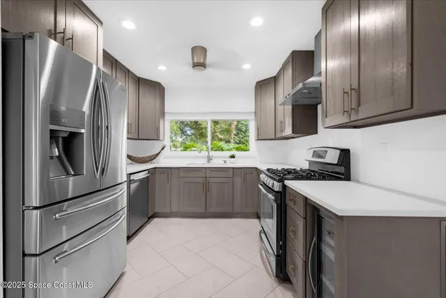 a kitchen with stainless steel appliances a refrigerator and a stove top oven
