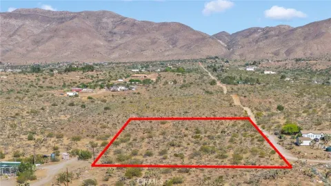 a view of a small house with a mountain