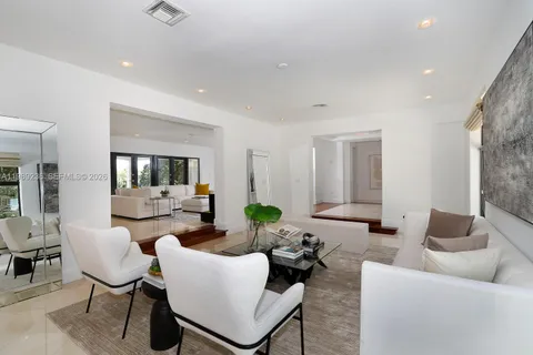 a living room with furniture a flat screen tv and a chandelier