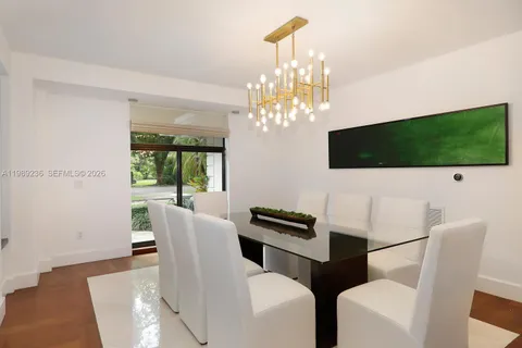 a view of a dining room with furniture and chandelier