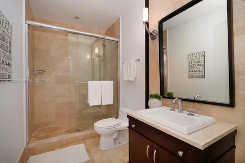 a spacious bathroom with a tub sink and mirror