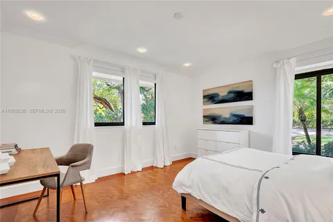 a bathroom with a tub a sink and mirror