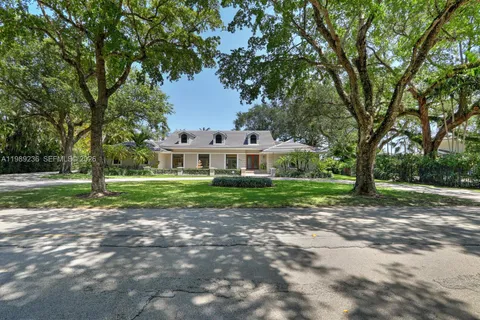 a front view of a house with yard patio and green space
