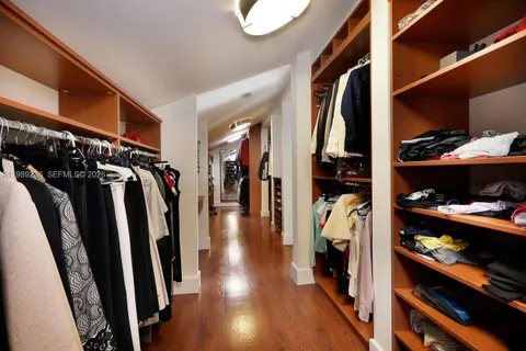 a view of a white house with a yard and potted plants