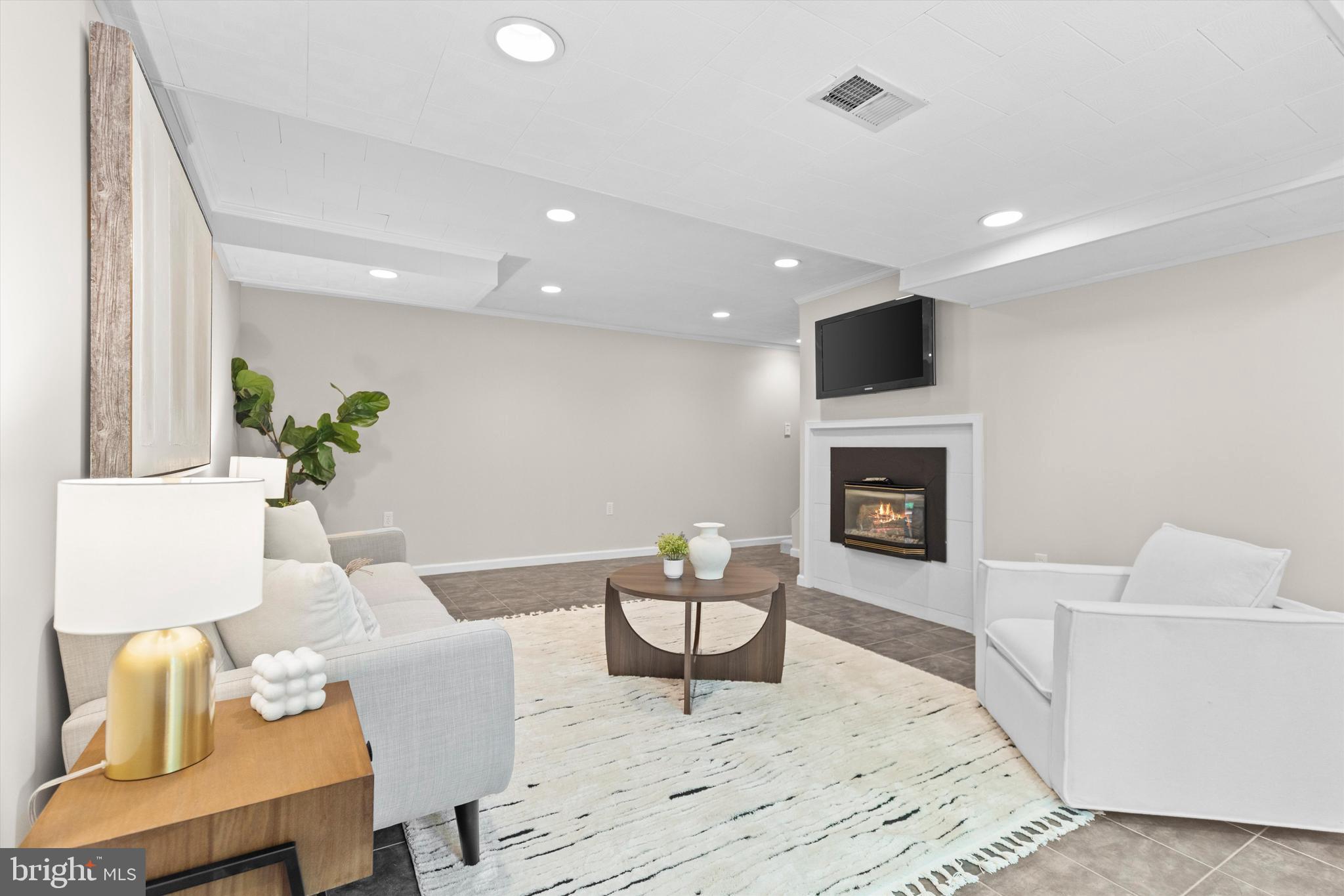 1918 Pagebrook Road Silver Spring, MD 20903 - Photo 20 of 24 a living room with furniture and a fireplace