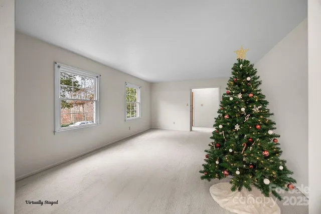 an empty room with a christmas tree