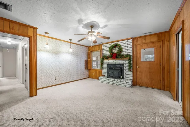 a view of an empty room with a fireplace