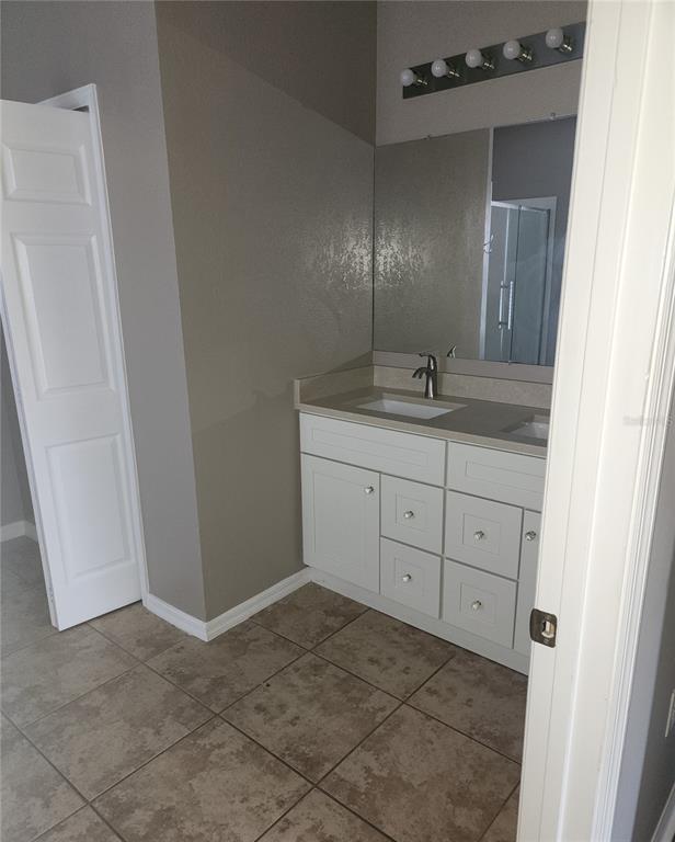 10969 Southwest 45th Avenue Ocala, FL 34476 - Photo 14 of 18 a bathroom with a granite countertop sink and a mirror