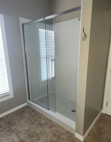 a bathroom with a shower and a window