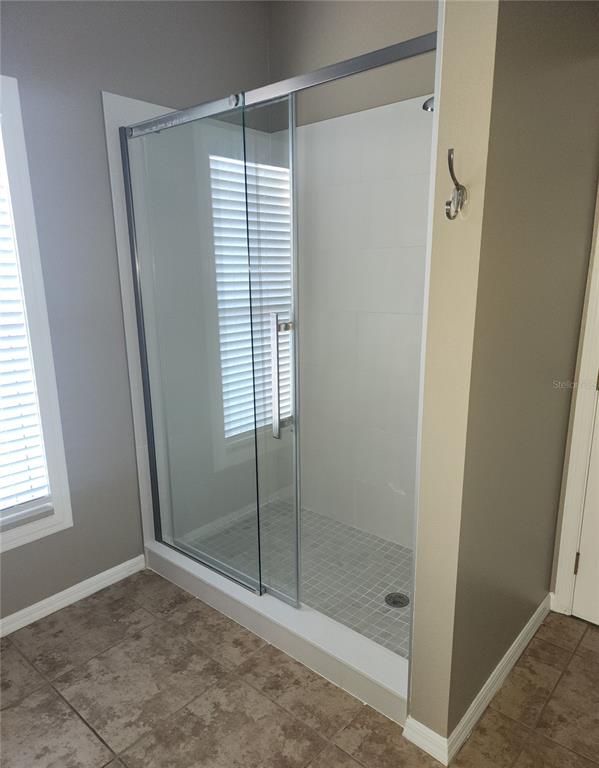 10969 Southwest 45th Avenue Ocala, FL 34476 - Photo 15 of 18 a bathroom with a shower and a window