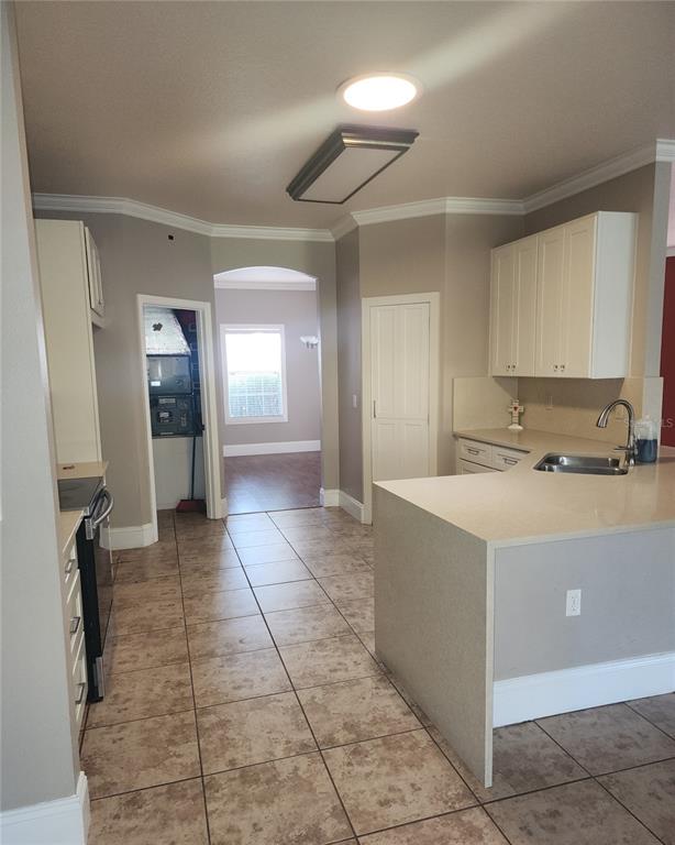 10969 Southwest 45th Avenue Ocala, FL 34476 - Photo 17 of 18 a view of a kitchen with a sink and a refrigerator