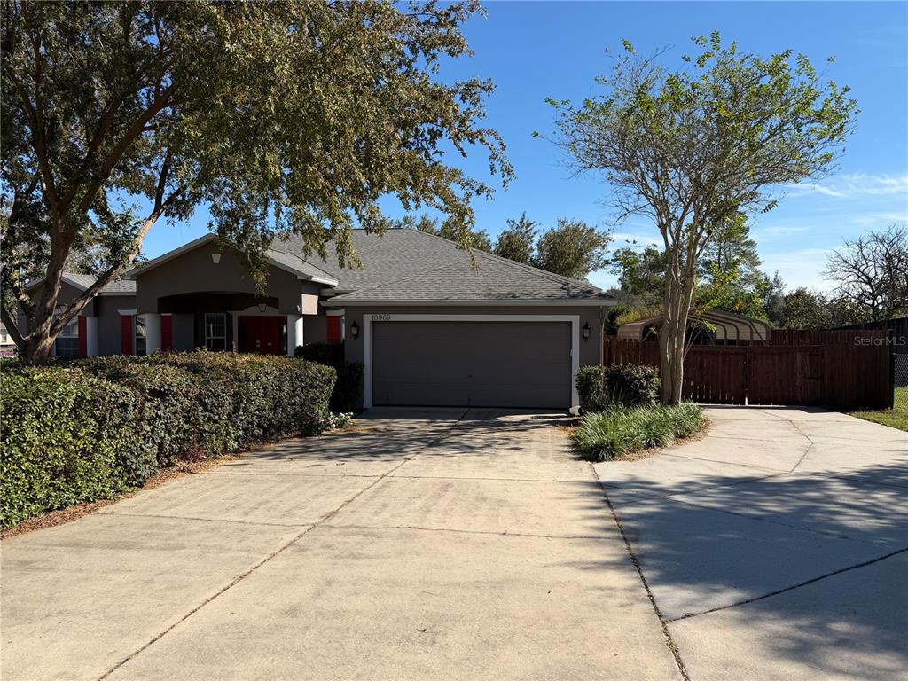 10969 Southwest 45th Avenue Ocala, FL 34476 - Photo 2 of 18 a front view of a house with a yard