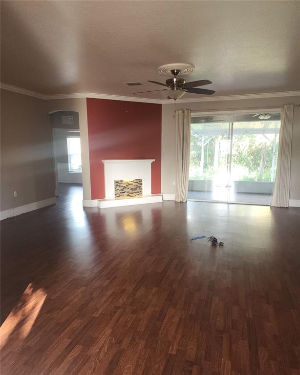 10969 Southwest 45th Avenue Ocala, FL 34476 - Photo 5 of 18 a view of empty room with wooden floor and fan