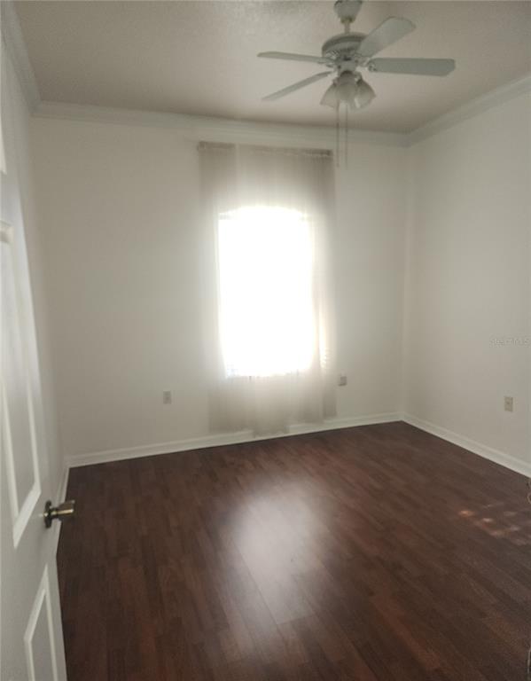 10969 Southwest 45th Avenue Ocala, FL 34476 - Photo 6 of 18 an empty room with wooden floor fan and windows