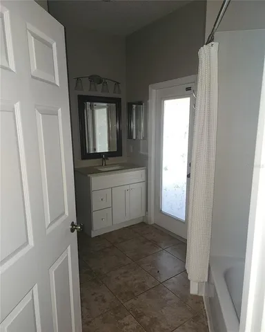 a view of a utility room with closet and mirror