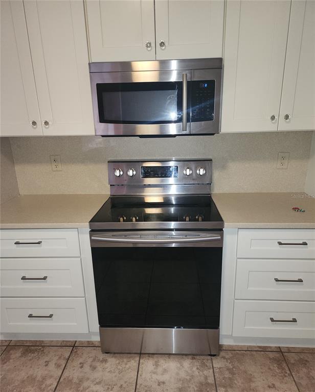10969 Southwest 45th Avenue Ocala, FL 34476 - Photo 10 of 18 a stove top oven sitting inside of a kitchen