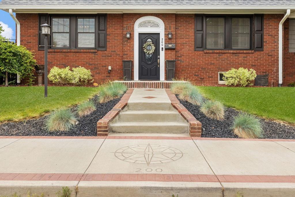 200 Orchard Street Beaver, PA 15009 - Photo 2 of 28 a front view of a house with garden