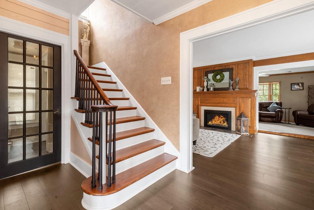200 Orchard Street Beaver, PA 15009 - Photo 7 of 28 a view of a livingroom with wooden floor staircase and a fireplace