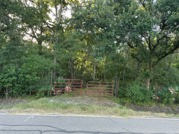 a backyard of a house with outdoor seating and trees