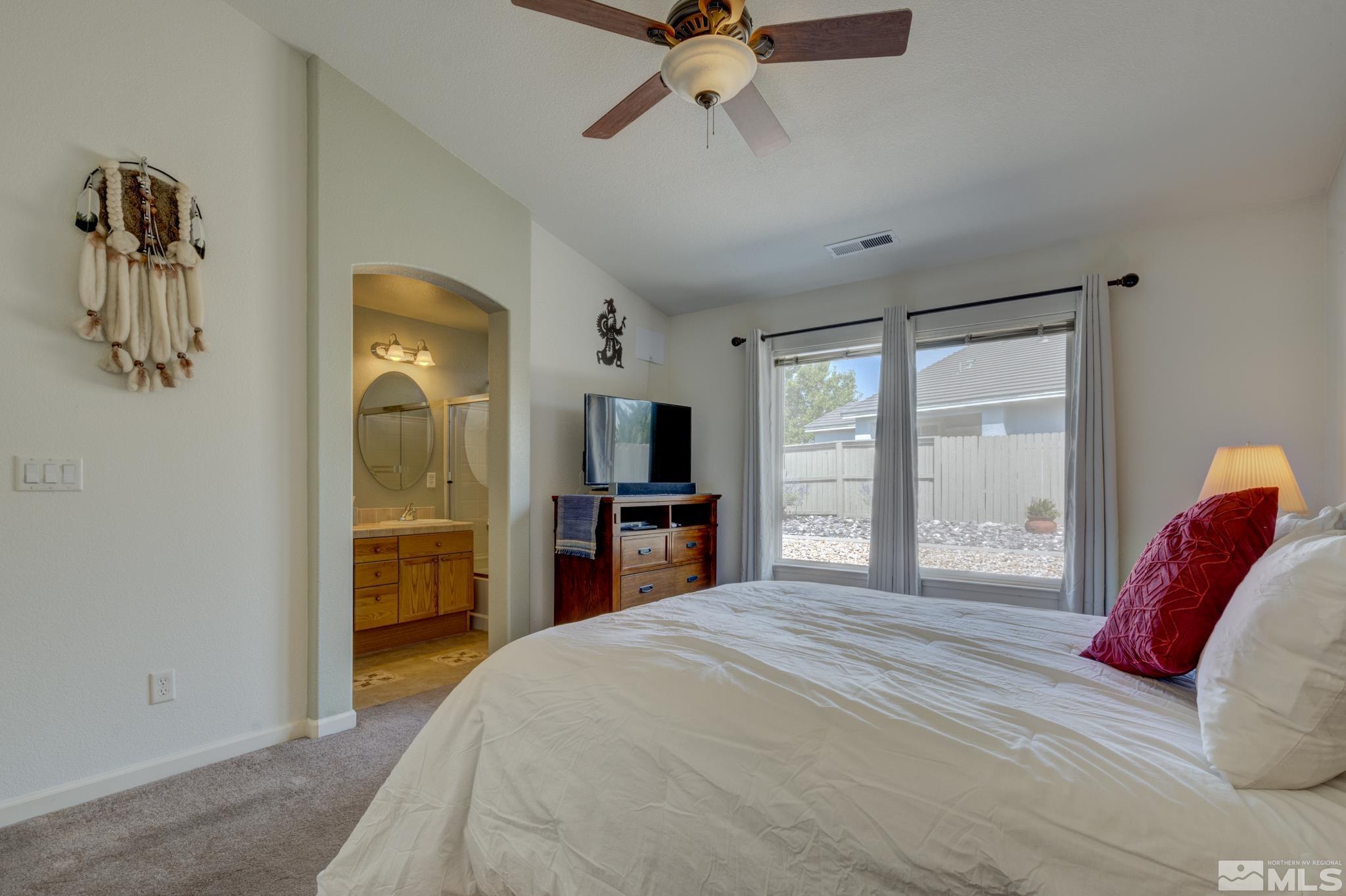 10695 Vista Bonita Lane Reno, NV 89521 - Photo 12 of 31 a bedroom with a bed and a large mirror