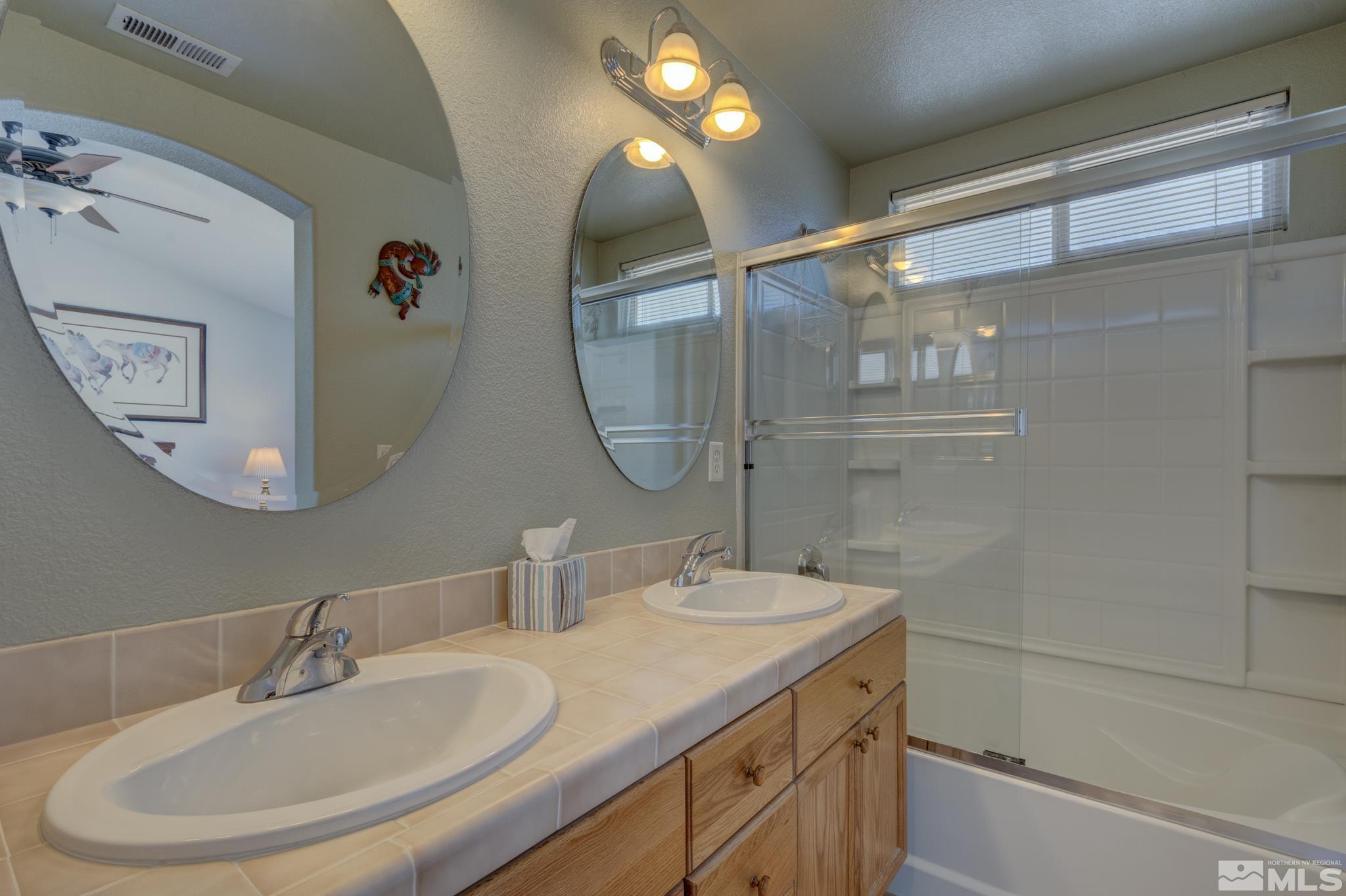 10695 Vista Bonita Lane Reno, NV 89521 - Photo 13 of 31 a bathroom with a sink and a mirror