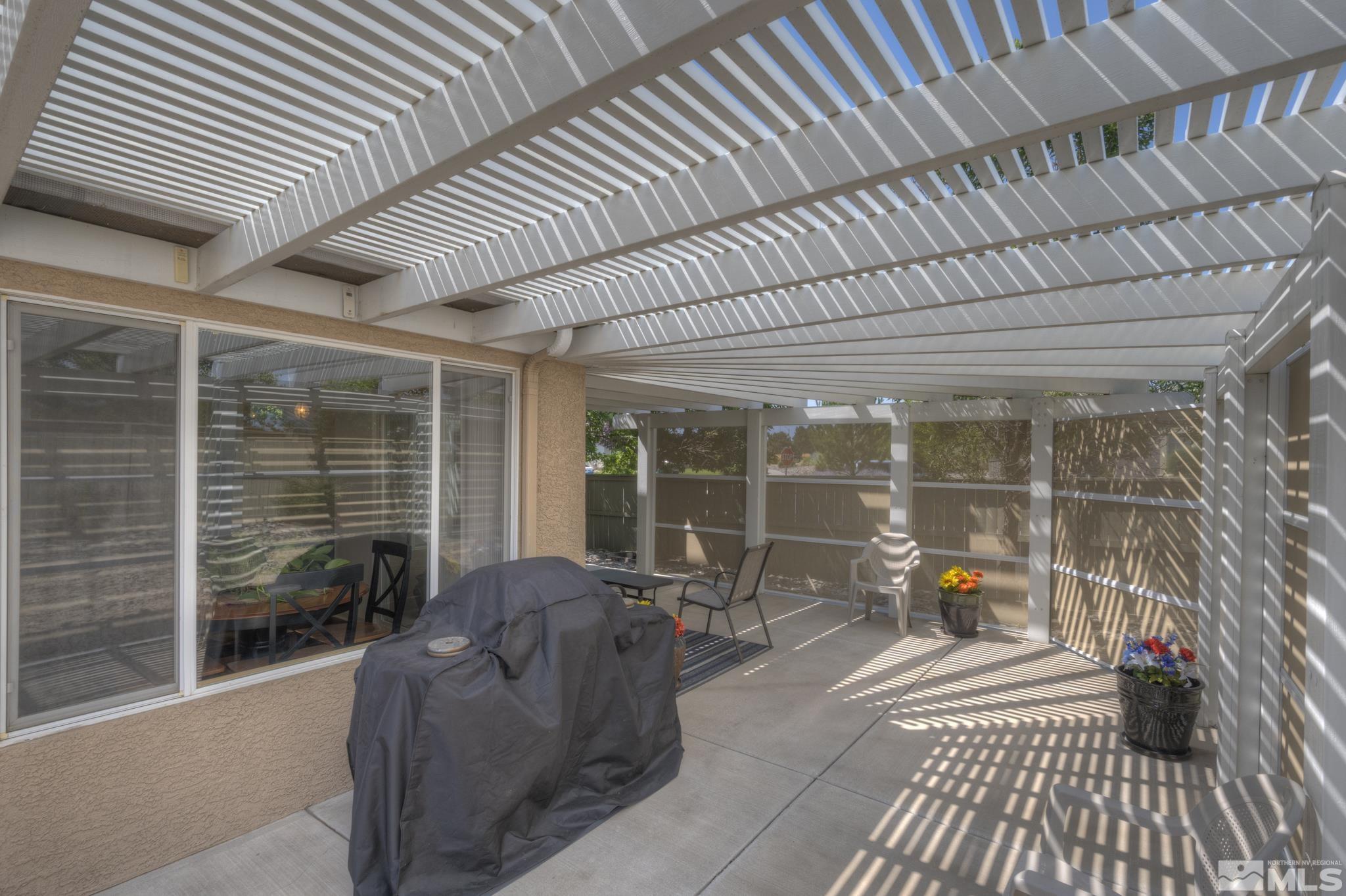 10695 Vista Bonita Lane Reno, NV 89521 - Photo 22 of 31 a view of a patio with table and chairs and wooden floor