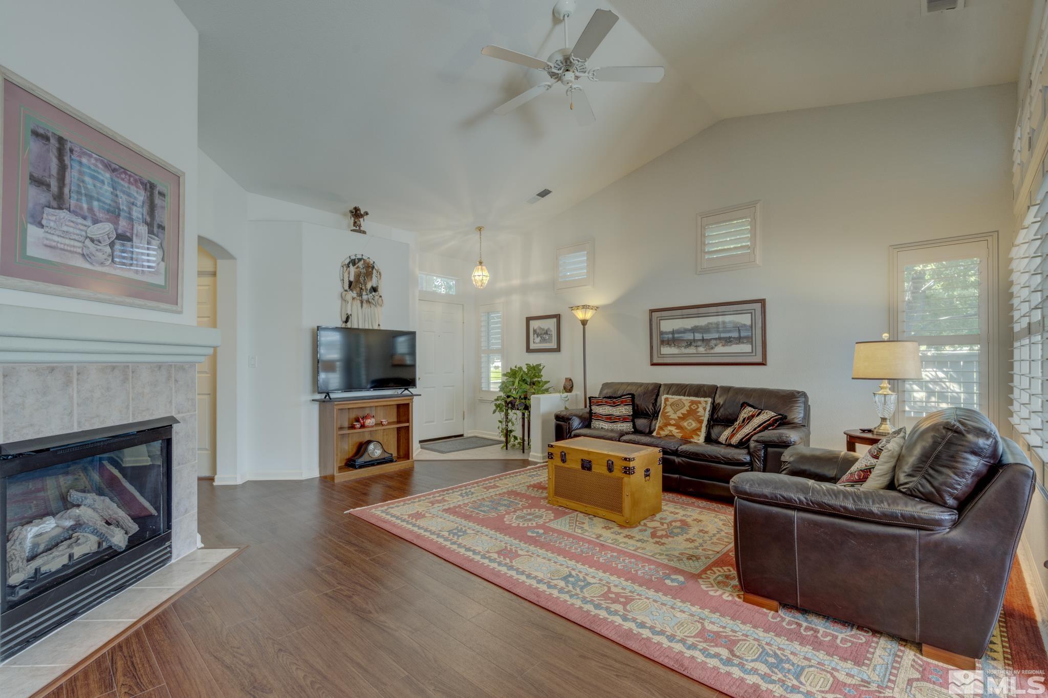 10695 Vista Bonita Lane Reno, NV 89521 - Photo 4 of 31 a living room with furniture a flat screen tv and a fireplace