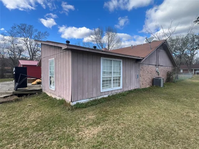 a backyard of a house with table and chairs