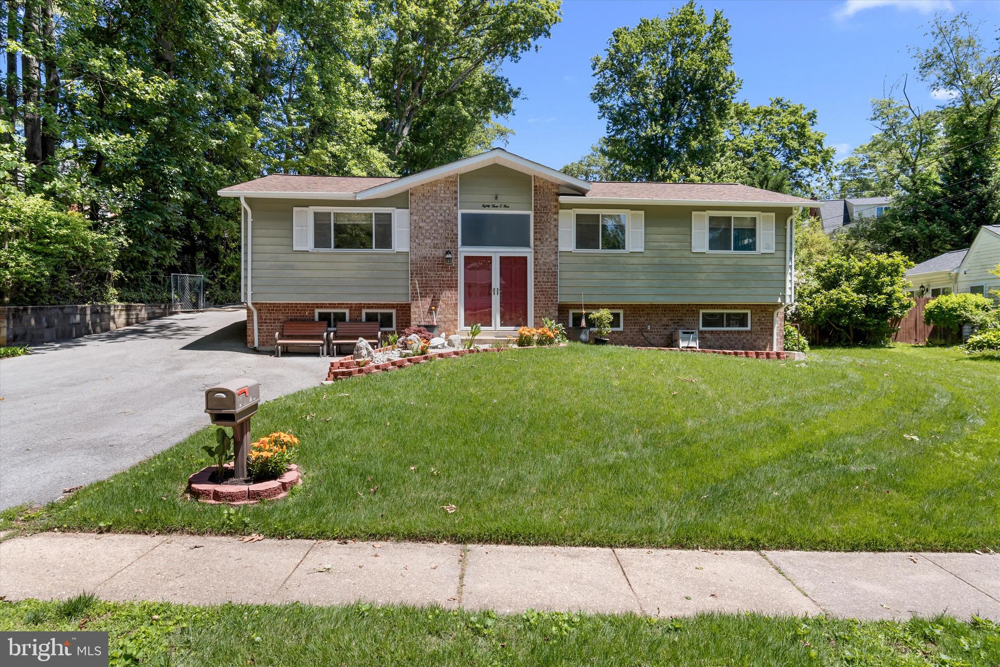 8304 Harland Drive Springfield, VA 22152 - Photo 2 of 39 a front view of a house with a yard patio and fire pit
