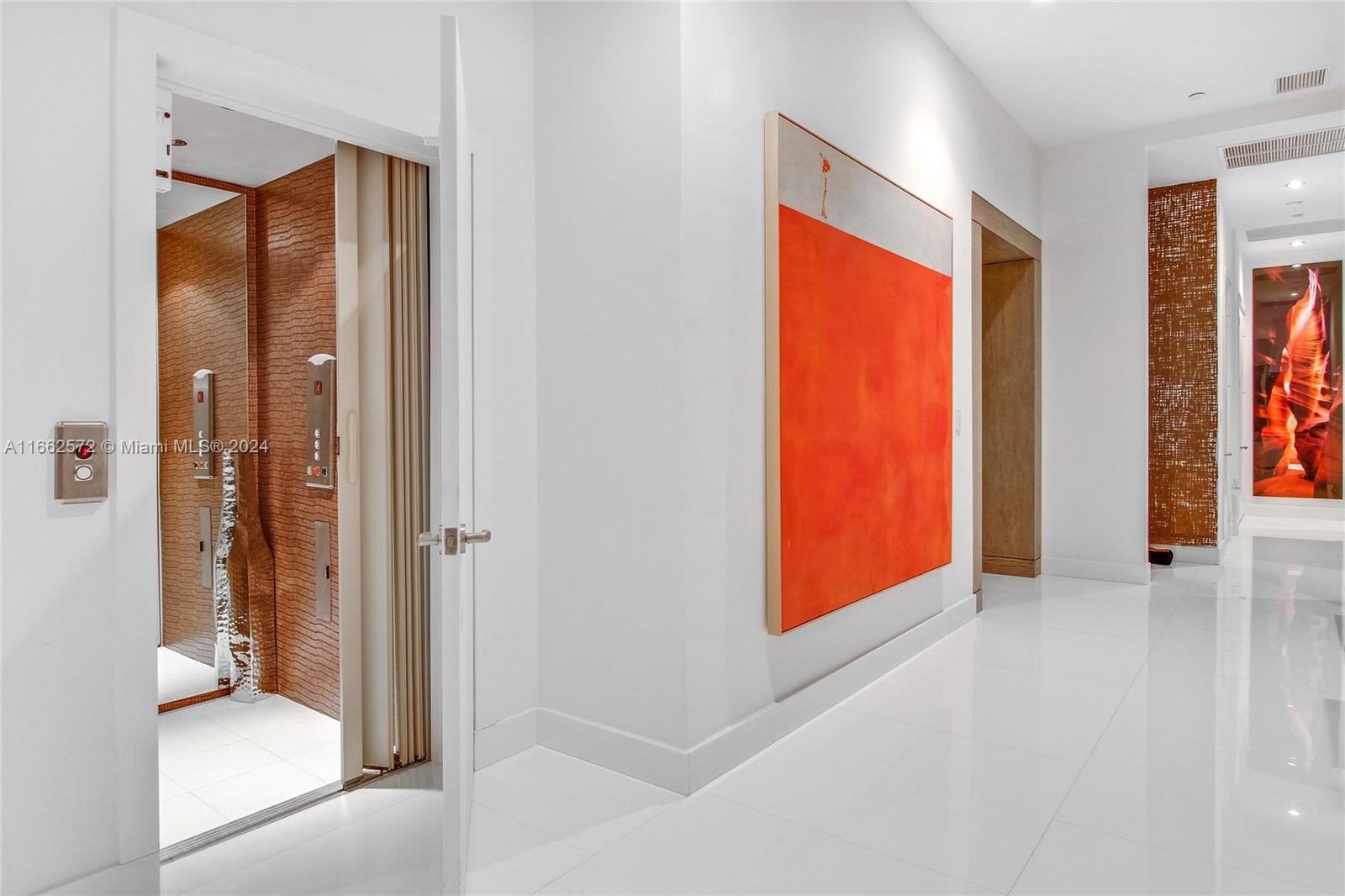 900 Brickell Key Boulevard, Unit PH3401 Miami, FL 33131 - Photo 18 of 58 a view of a hallway with bathroom and a glass door