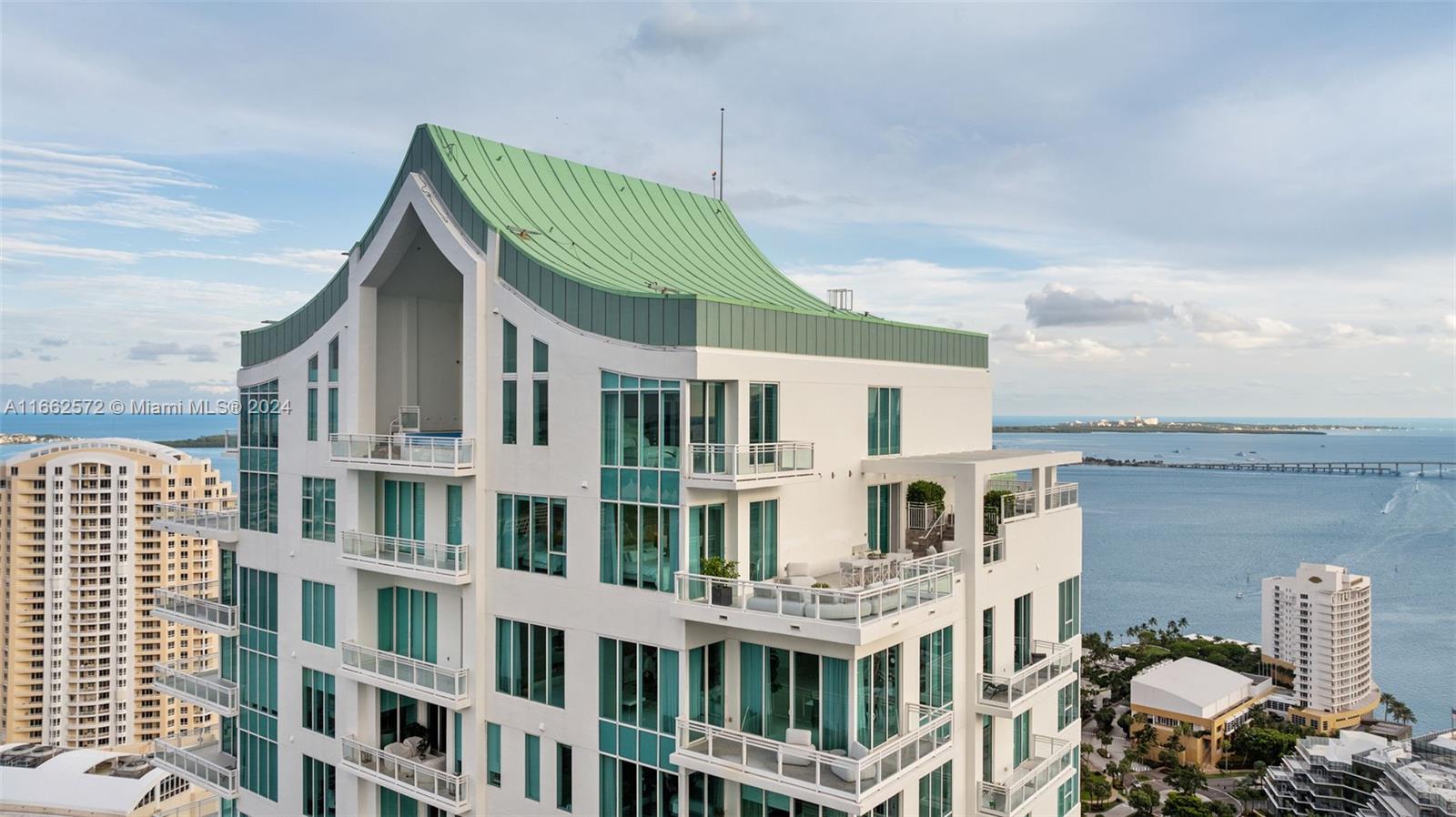 900 Brickell Key Boulevard, Unit PH3401 Miami, FL 33131 - Photo 2 of 58 a front view of a residential apartment building with a yard