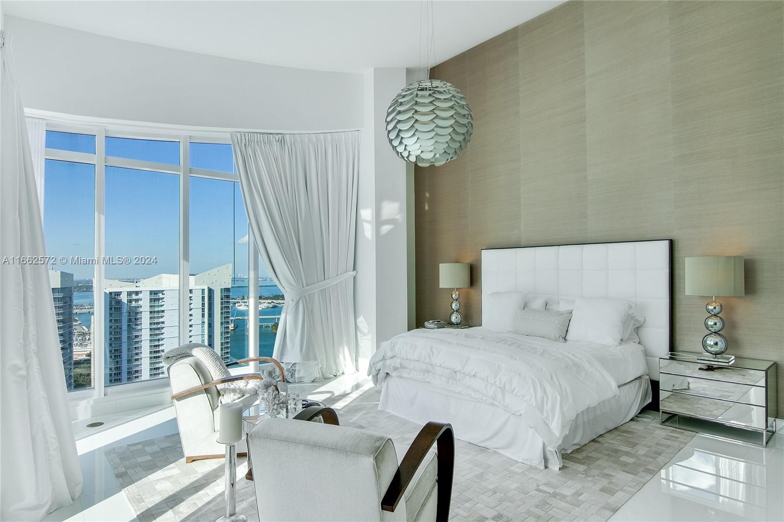 900 Brickell Key Boulevard, Unit PH3401 Miami, FL 33131 - Photo 21 of 58 a bedroom with a bed and a chair