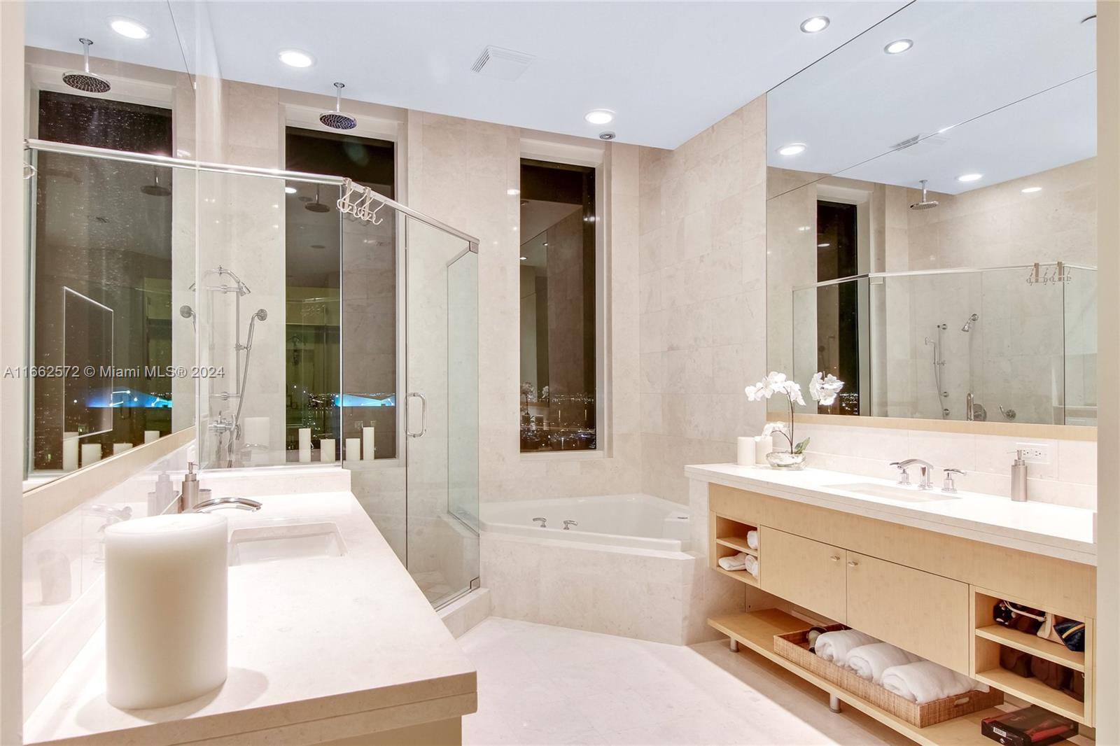 900 Brickell Key Boulevard, Unit PH3401 Miami, FL 33131 - Photo 23 of 58 a bathroom with a tub sink and mirror