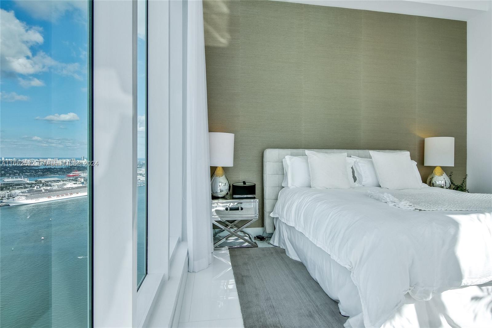 900 Brickell Key Boulevard, Unit PH3401 Miami, FL 33131 - Photo 25 of 58 a bedroom with a bed and view of living room