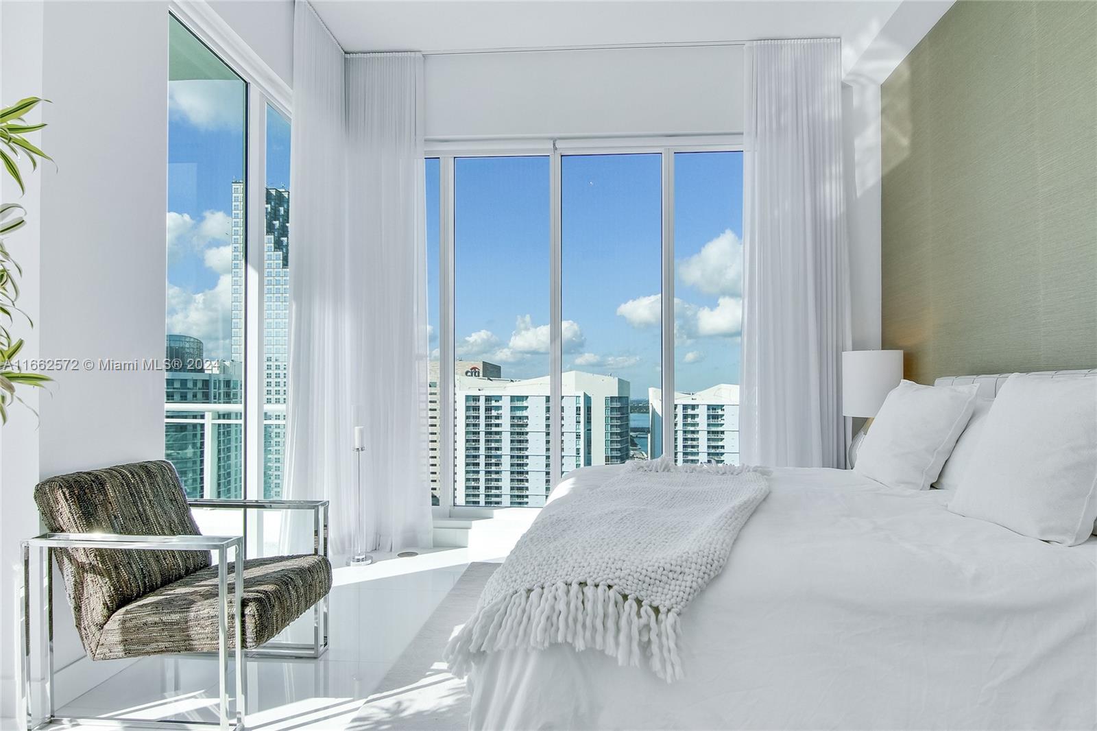 900 Brickell Key Boulevard, Unit PH3401 Miami, FL 33131 - Photo 26 of 58 a bedroom with a bed and glass door