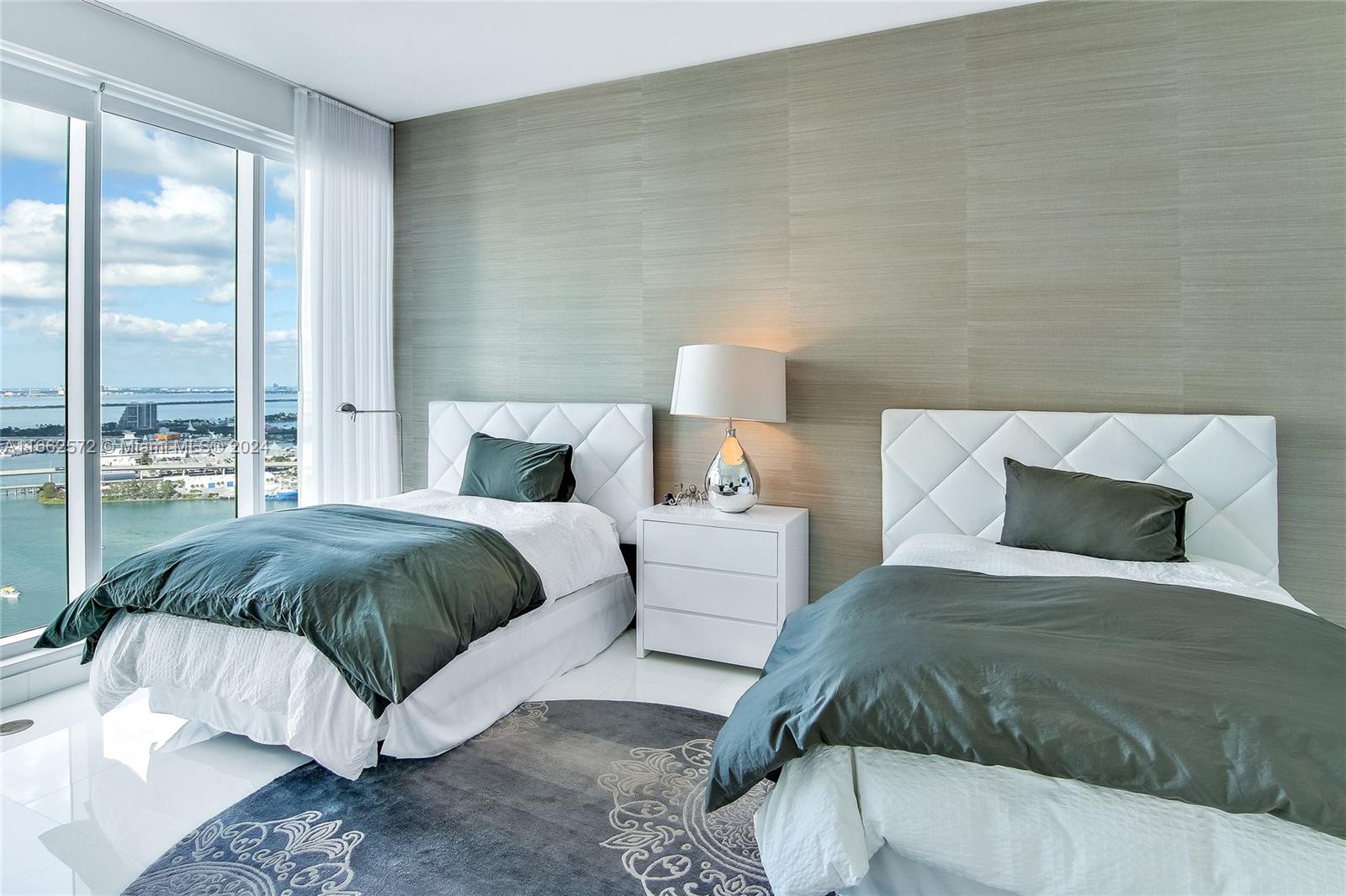900 Brickell Key Boulevard, Unit PH3401 Miami, FL 33131 - Photo 27 of 58 a bedroom with a bed and large window