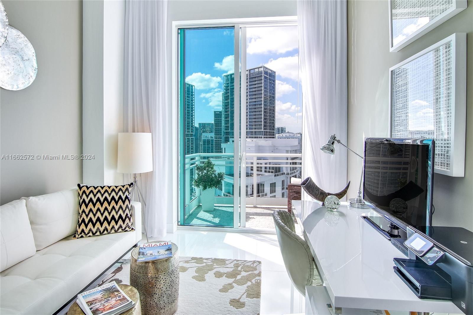 900 Brickell Key Boulevard, Unit PH3401 Miami, FL 33131 - Photo 29 of 58 a living room with furniture and wooden floor