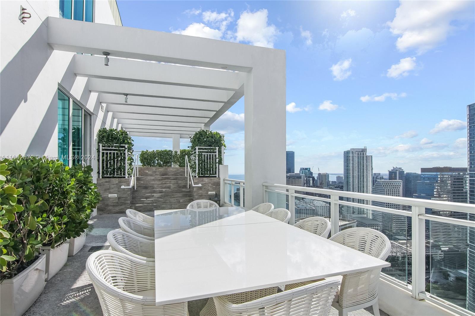 900 Brickell Key Boulevard, Unit PH3401 Miami, FL 33131 - Photo 31 of 58 a view of a patio with couches chairs and potted plants