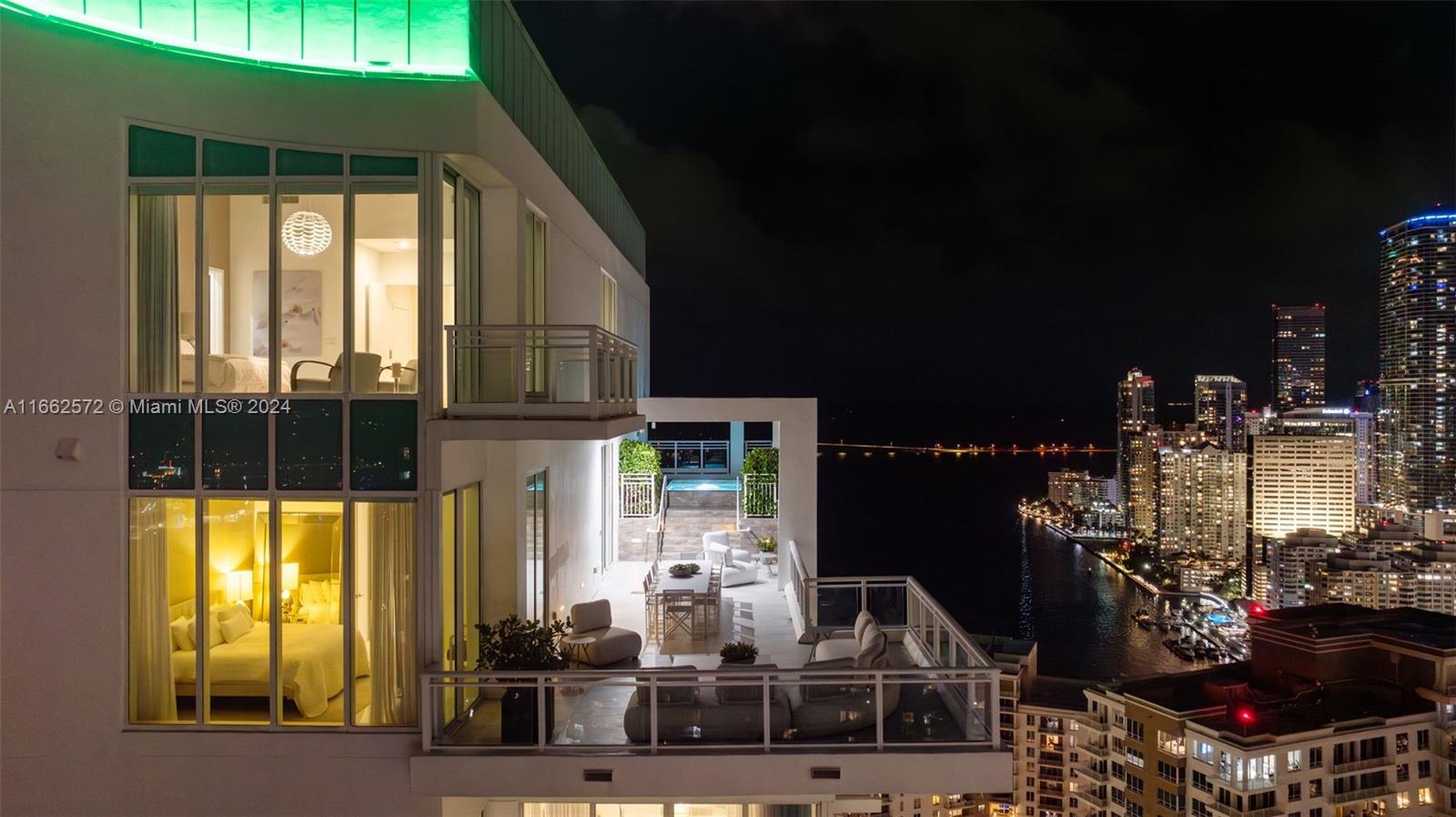 900 Brickell Key Boulevard, Unit PH3401 Miami, FL 33131 - Photo 35 of 58 a front view of a house with a yard