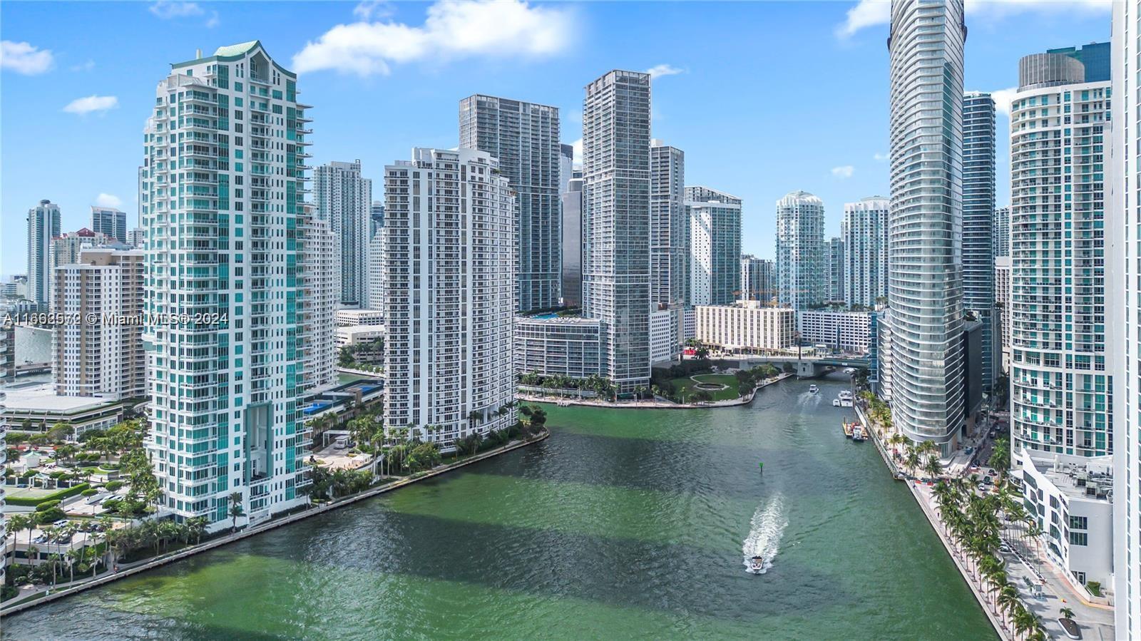 900 Brickell Key Boulevard, Unit PH3401 Miami, FL 33131 - Photo 40 of 58 a lake with tall building in the background