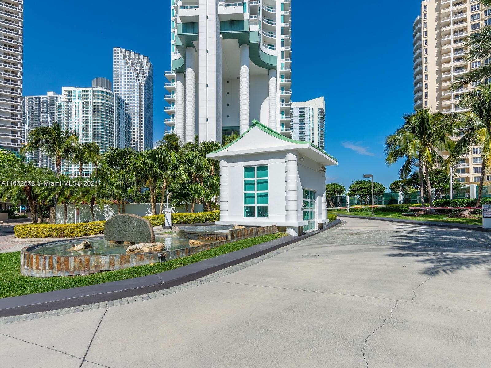 900 Brickell Key Boulevard, Unit PH3401 Miami, FL 33131 - Photo 41 of 58 a front view of a building with garden and trees