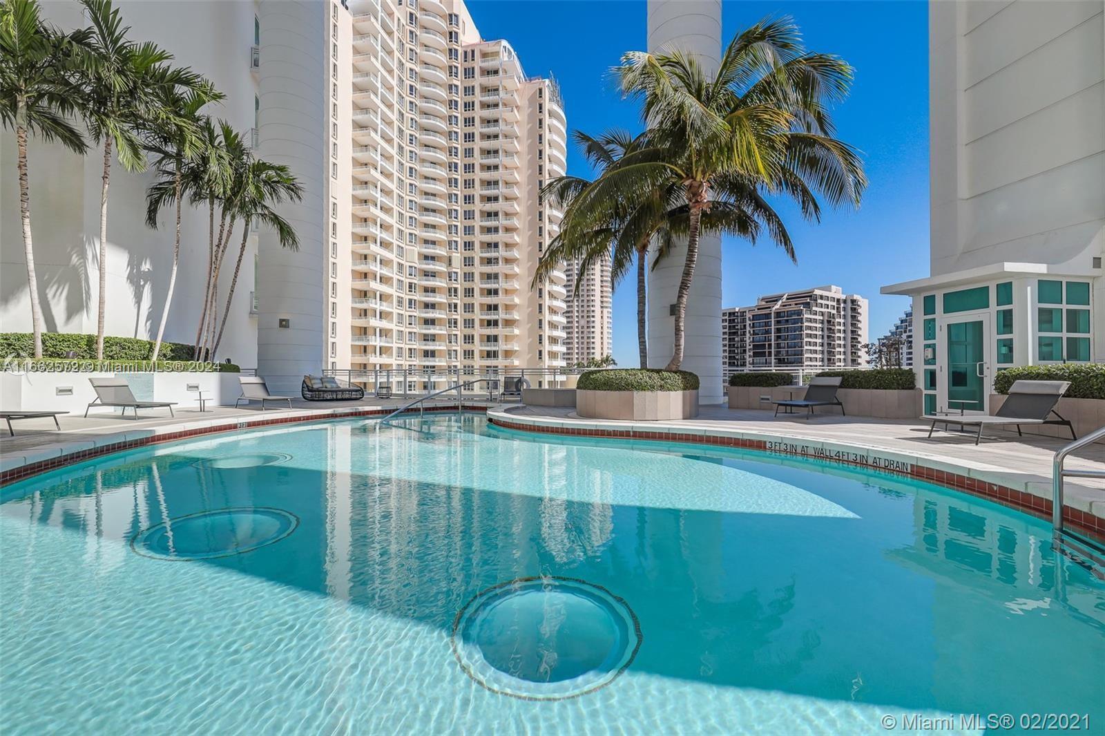 900 Brickell Key Boulevard, Unit PH3401 Miami, FL 33131 - Photo 45 of 58 a swimming pool with outdoor seating and yard