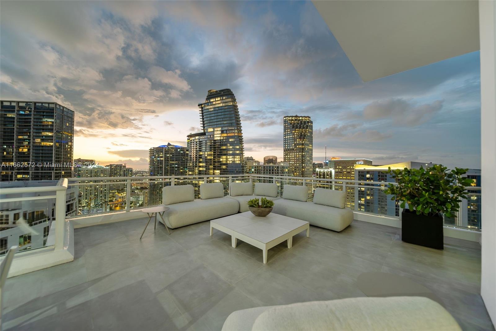 900 Brickell Key Boulevard, Unit PH3401 Miami, FL 33131 - Photo 5 of 58 a view of roof deck with couches and potted plants