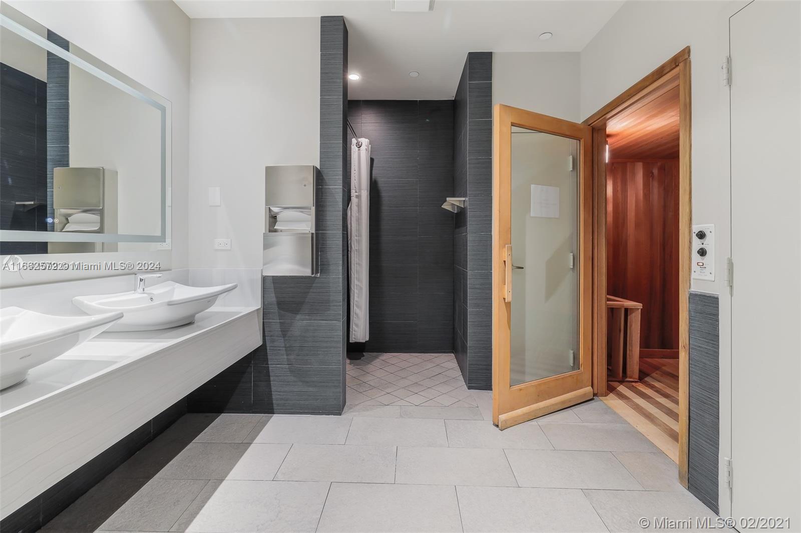 900 Brickell Key Boulevard, Unit PH3401 Miami, FL 33131 - Photo 51 of 58 a bathroom with a double vanity sink and a mirror
