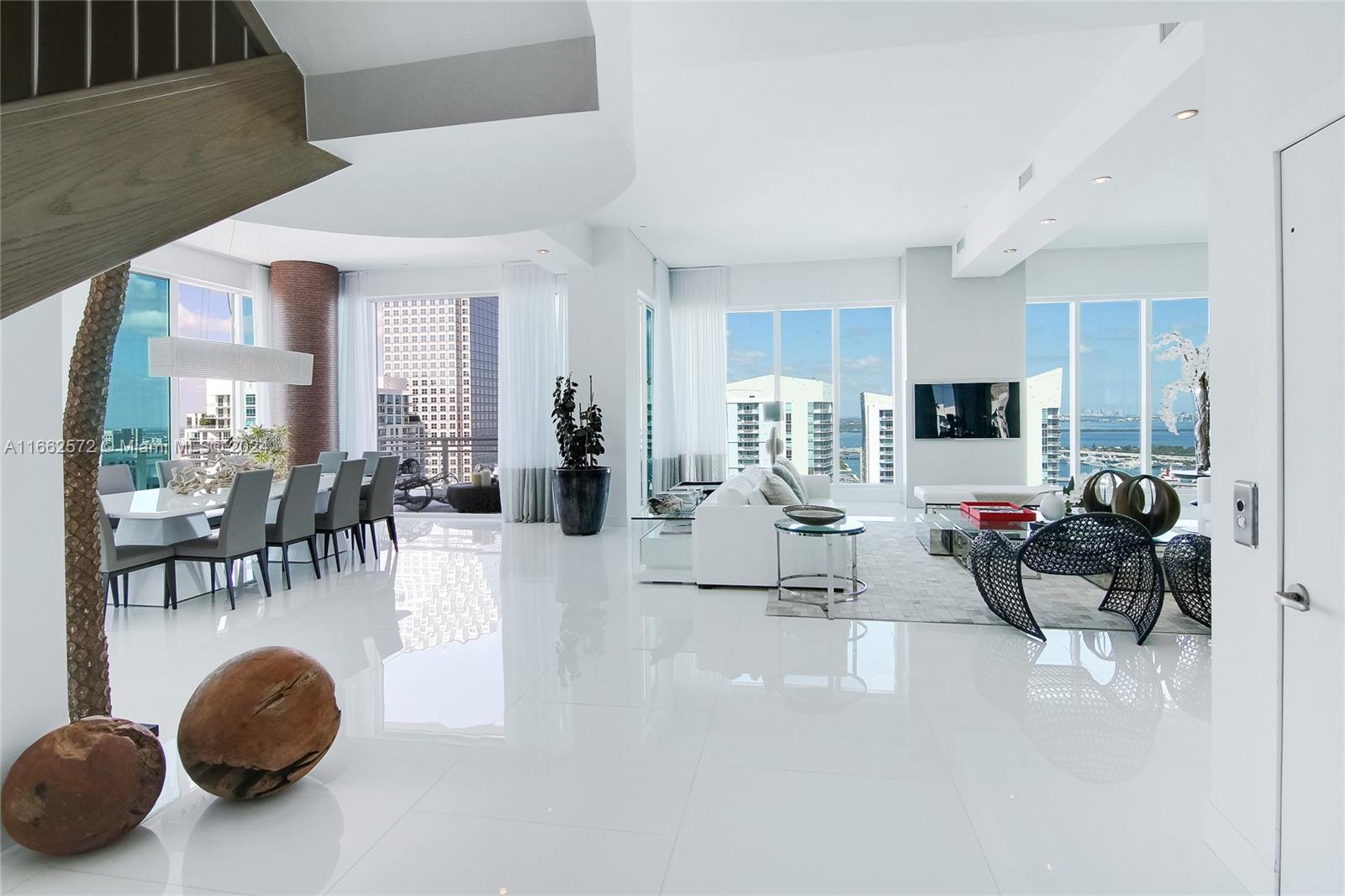 900 Brickell Key Boulevard, Unit PH3401 Miami, FL 33131 - Photo 8 of 58 a living room with furniture and a large window